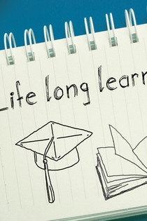A notepad with "life long learning" written on it