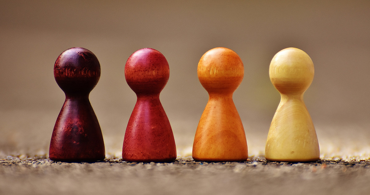different colored wooden board game figures 