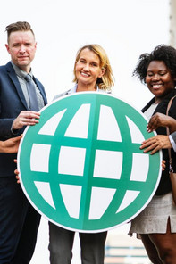 MBA students hold a globe