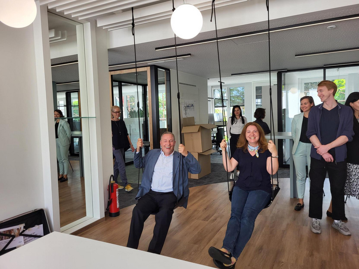 Two of our alumni enjoying some swing time during our touring of the new office space at Silhouette.