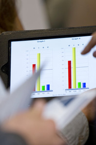 Two bar charts compared to another on a laptop