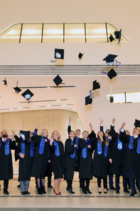 Graduates of the Executive MBA Bucharest throw their hats in the air.