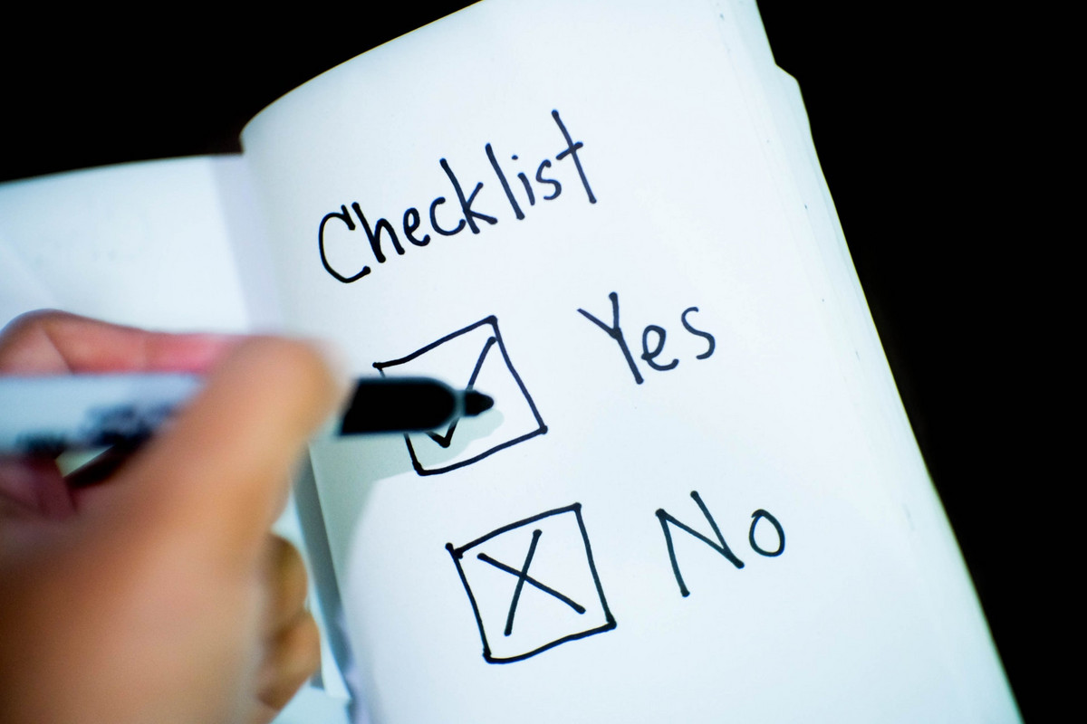 A close-up of a notebook, with the words "Checklist - Yes - No" written in it.