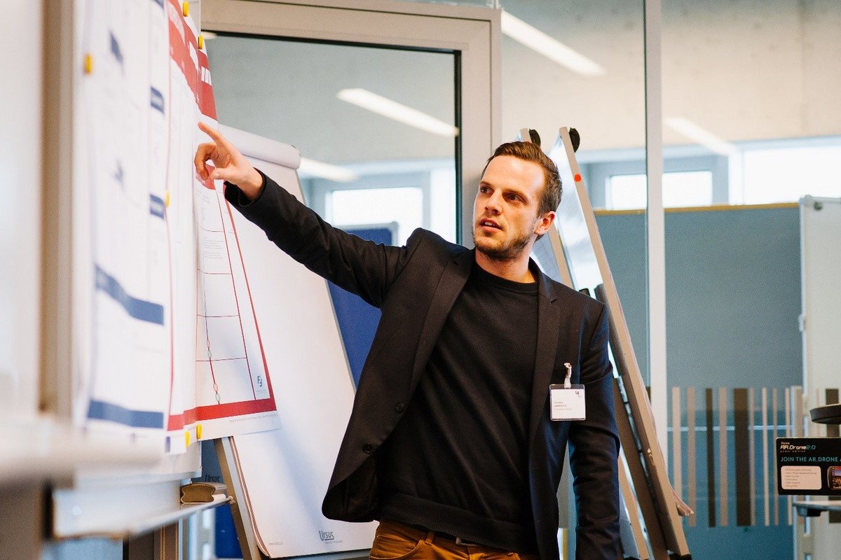 A man pointing at a whiteboard