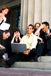 Professional MBA students sit in front of a computer