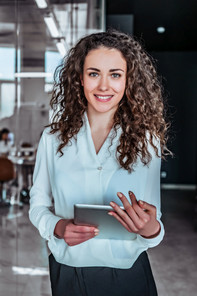 A young business woman holding a tablet