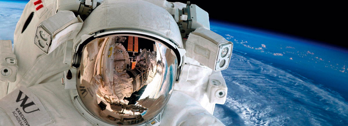 An astronaut close up on the helmet floats above the globe