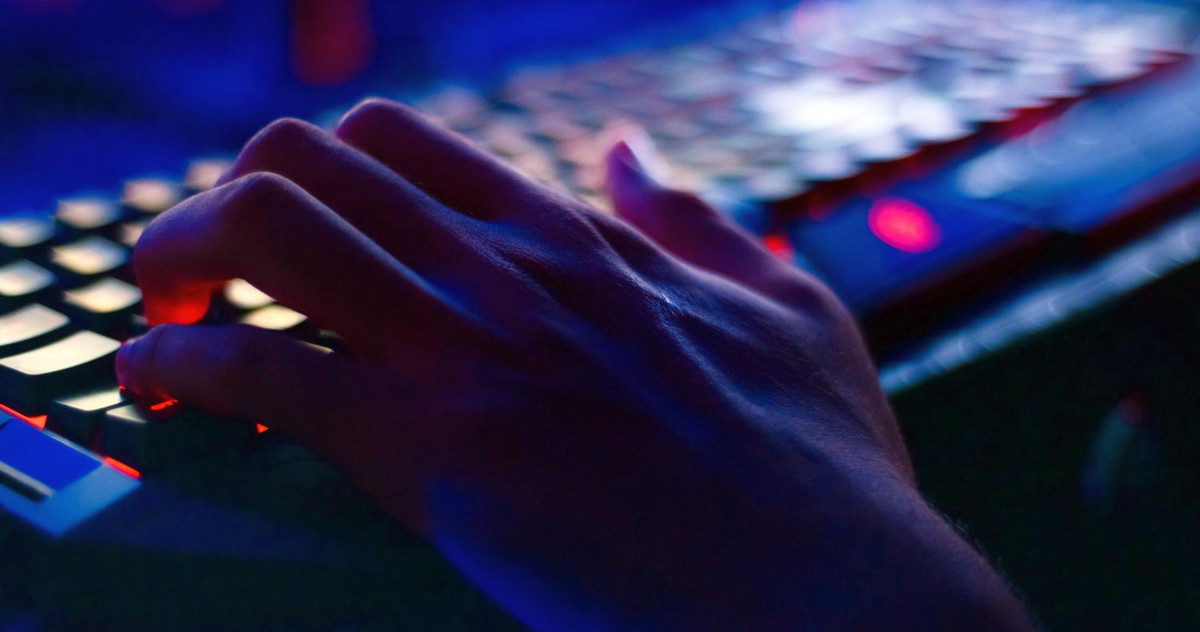 Picture of a hand hovering over a keyboard