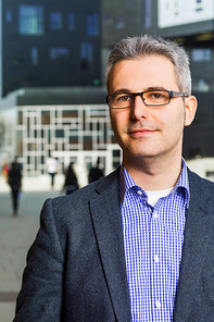 Picture of a man standing in front of the Executive Academy