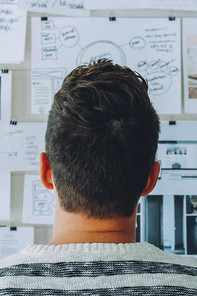 A man is studying notes about the topic of innovation