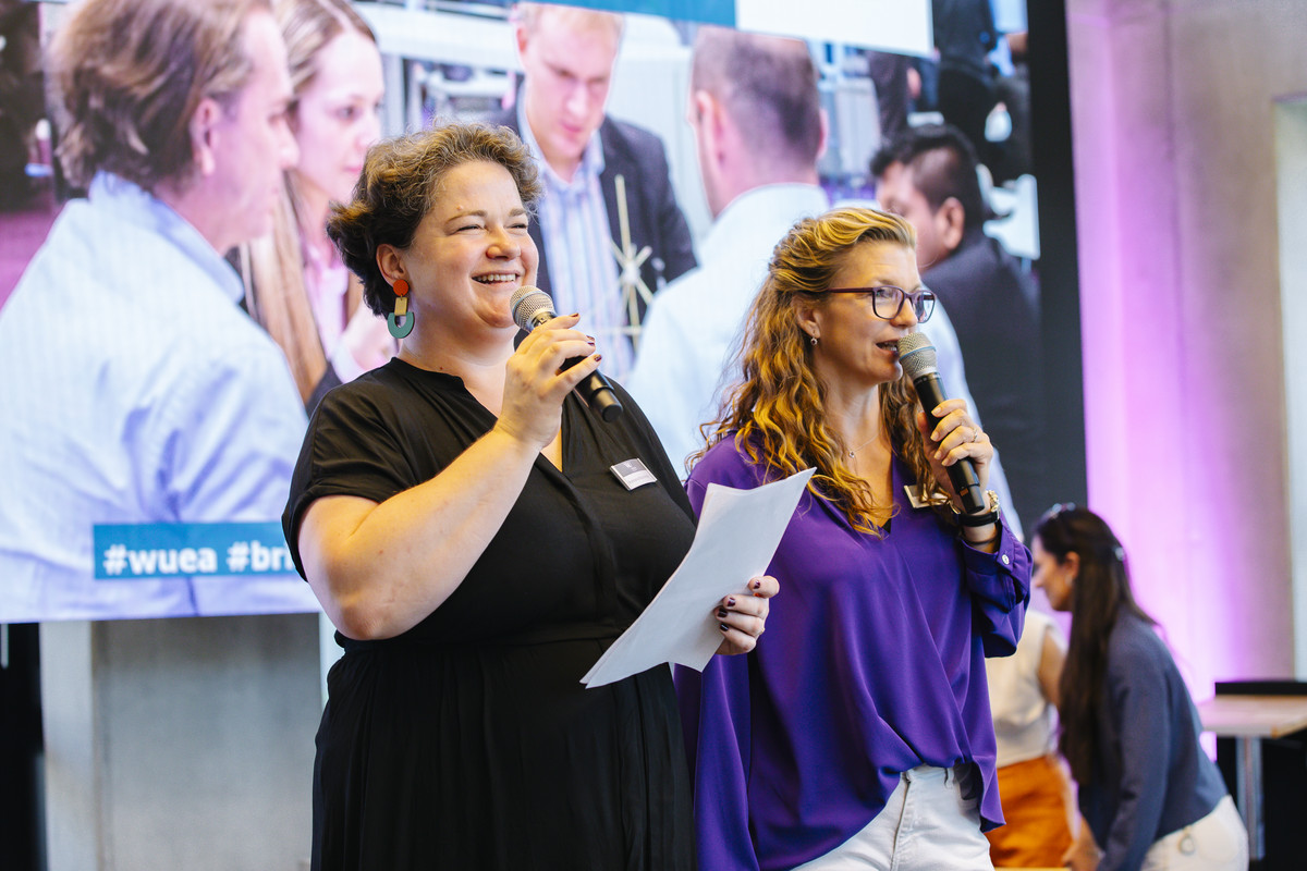 Romana Roschinsky and Regine Eitelbös from the Community Engagement Team welcoming the participants and introducing the group activity during Bridging the Years 2024.