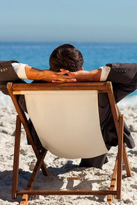 A business man is relaxing on the beach