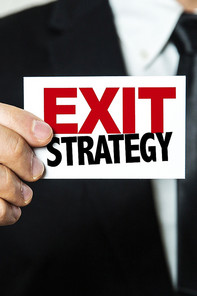 Man holding a sign that says: "Exit Strategy"