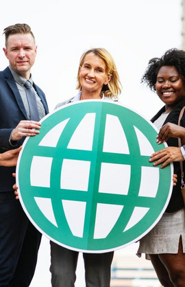 MBA students hold a globe