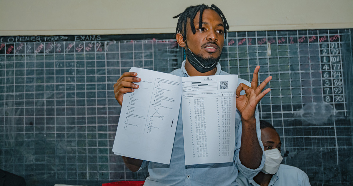  A man shows a sheet of paper with data on it
