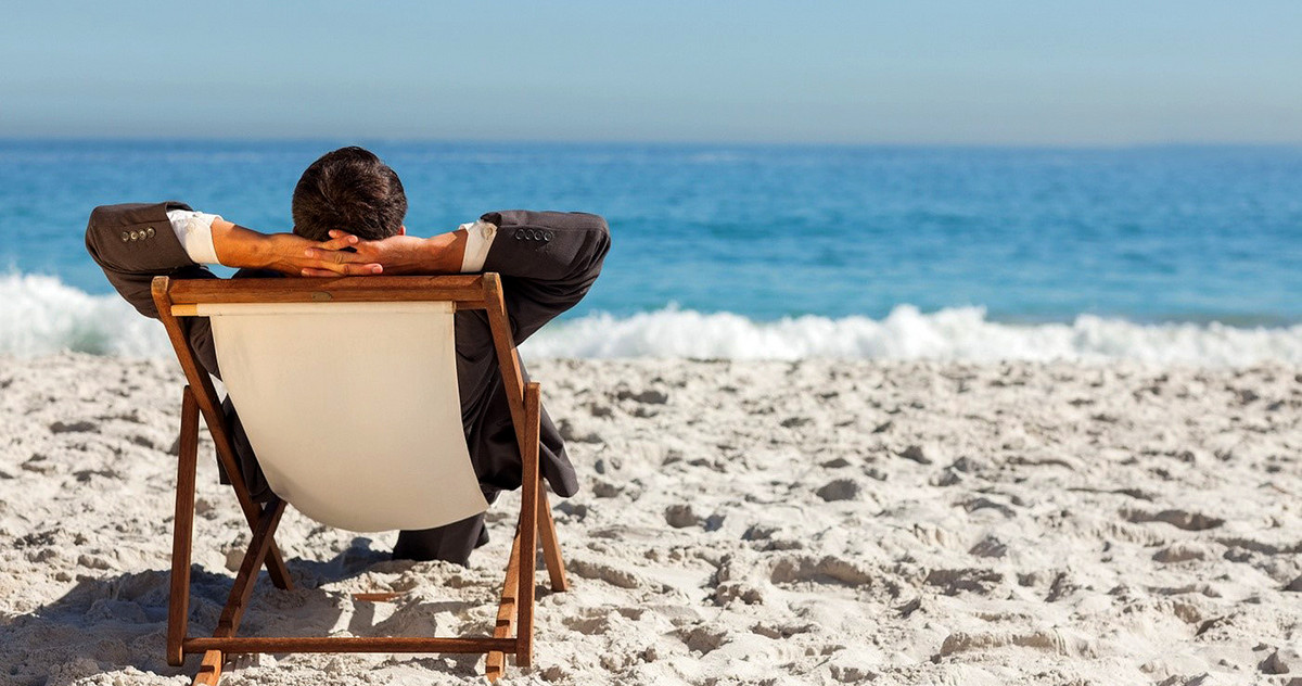 A business man is relaxing on the beach