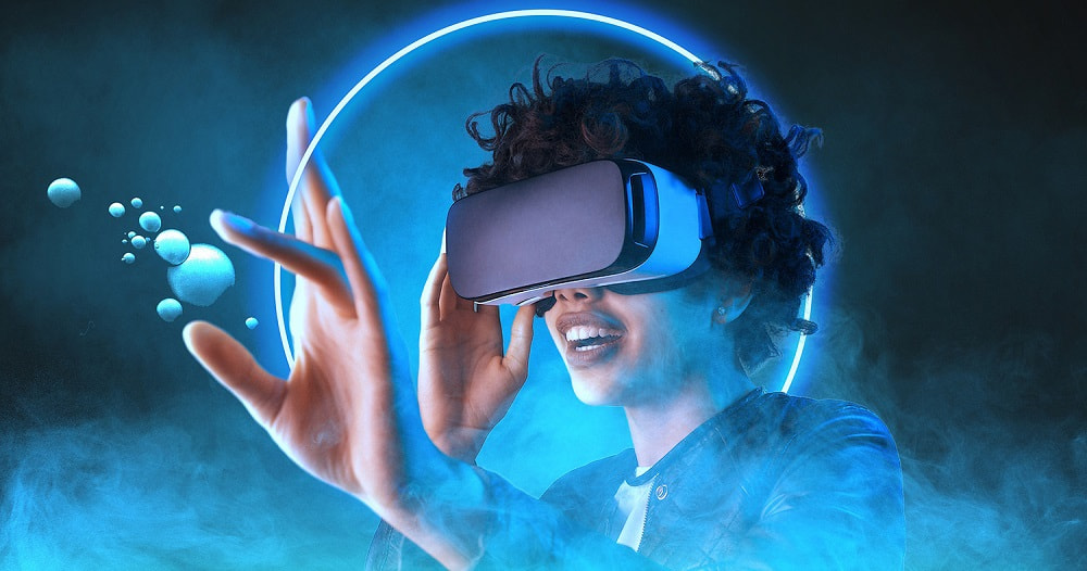 A woman wearing VR goggles, grabbing virtual bubbles